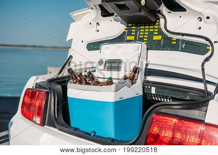 Close Up View Of Portable Fridge With Beer Standing In Car