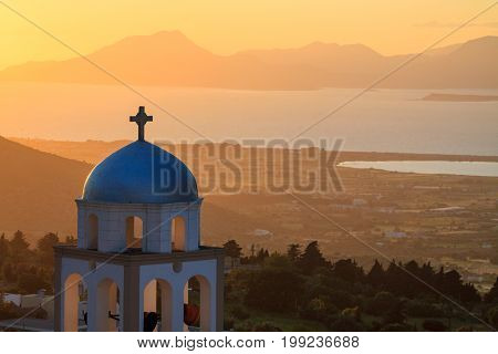 Sunset view with church belfry from Asfendiou village in Kos island Greece