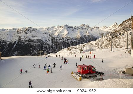 Austrian ski resort Ischgl with skiers. Alps.