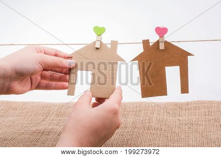 Hand Holding A Paper House On Canvas