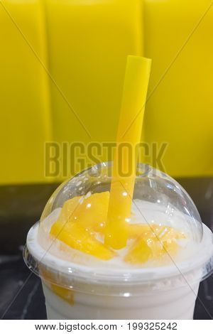 Yogurt pudding with slice of mango in takeaway glass