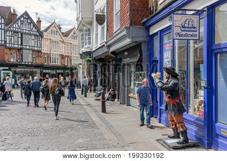 CANTERBURY ENGLAND - JUNE 07 2017: Shopping street with people downtown old historic Canterbury city Kent England
