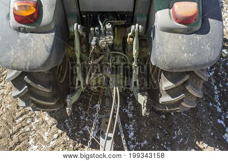 Farming tractor pulling a trailer. Attaching area detail. Overhead view