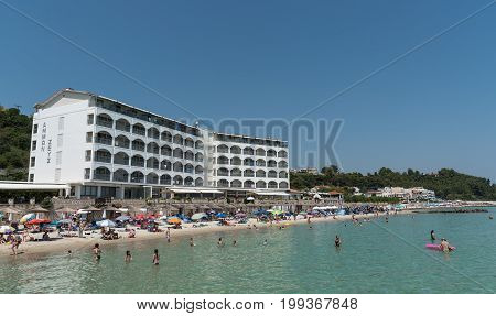 Chalkidiki Greece- July 24 2017: Famous and idyllic beach of Kallithea s with people swimming resting and enjoying their summer vacations at Kasandra peninsula in Chalkidiki Greece