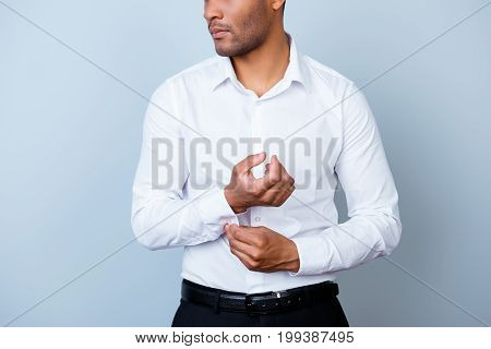 Close Up Cropped Photo Of Young Handsome African Businessman Lawyer In A Suit, Fixing His Cuffl Inks