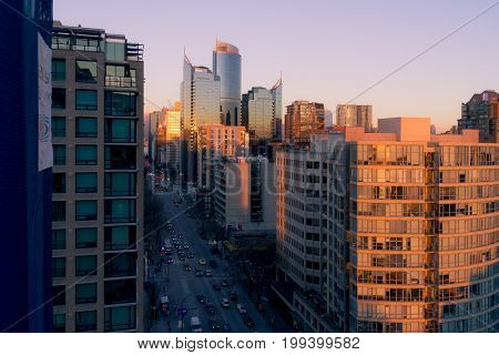 Morning Cityscape With Sunrise Illuminating Top Of Building