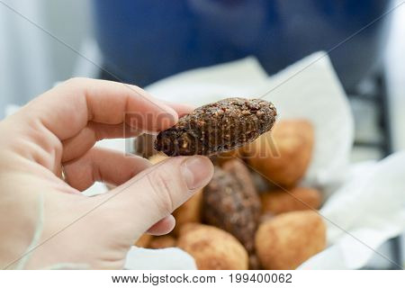 Hand Holding Deep Fried Brazilian Kibbe