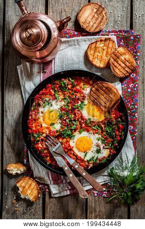 Shakshouka Middle East and North Africa Dish of Poached Eggs in a Sauce of Tomatoes Chili Peppers and Spices top view