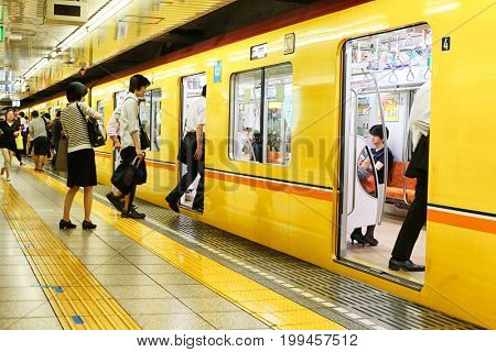 Tokyo, Japan - August 10, 2016: Passengers traveling by Tokyo metro. Business people commuting to work by public transport in rush hour. In Tokyo, Japan 