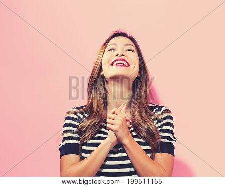 Successful young woman on a pink background