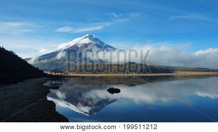 Cotopaxi volcano reflected in the water of Limpiopungo lagoon on a cloudy morning - Ecuador