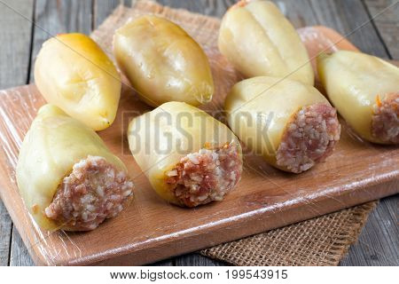 Raw stuffed peppers on a cutting board