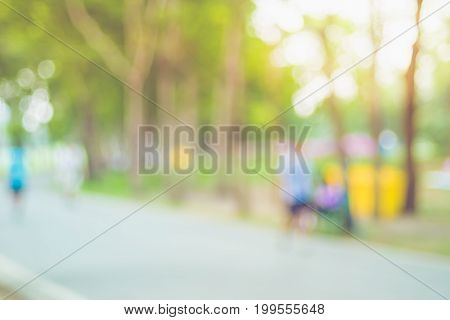Blurred Background,people Exercise At Green Park With Bokeh Light. Healthy Lifestyle Concept