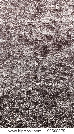 Background of foil. Silver and rose color. Argent. Sparkle wrinkled texture. Gray metallic.