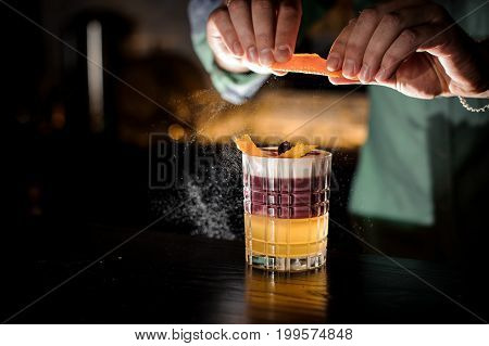 Bartender decorates New York sour cocktail no face