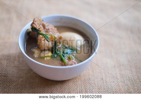 Eggs stewed pork with tofu in white bowl