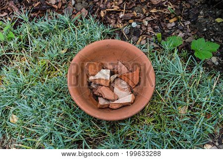 earthenware flower pot with cracked pieces inside used for gardening