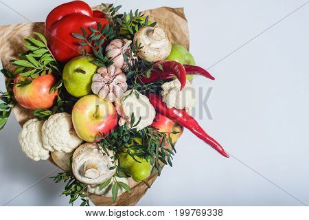 autumn bouquet of fresh fruits vegetables and mushrooms as concept of accumulate vitamins for the winter