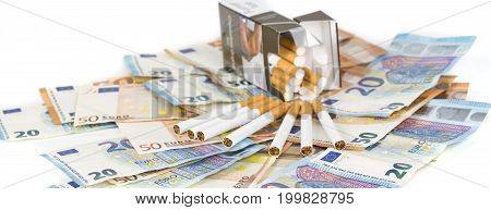 20 and 50 Euro banknotes bills cash with cigarettes with cigarettes box. Concept of cost of tabacco cigarettes. Front and top view close-up. On white background. Panormaic picture