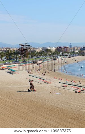 SALOU SPAIN - MAY 25: The tourists enjoiying their vacation on the beach on May 25 2015 in Salou Spain. Up to 60 mln tourists is expected to visit Spain in year 2015.