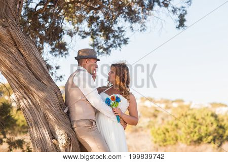 Just married couple embraced on nature. Bride and groom.