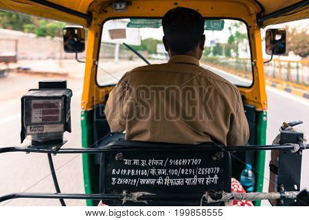 JODHPUR RAJASTHAN INDIA - MARCH 04 2016: Wide angle picture from the back of a tuk tuk driver at Jodhpur the blue city of Rajasthan in India.