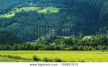 Background landscape view of aAncient castle among the fields in Tyrol, Austria