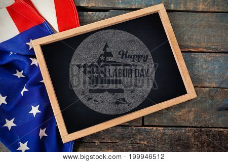 Digital composite image of happy labor day text on blue poster against american flag with chalkboard on table