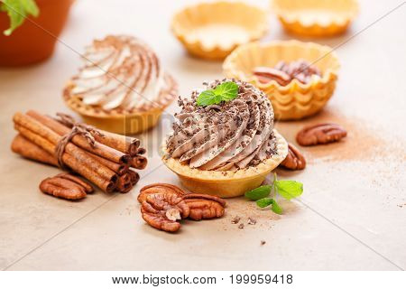 Delicious tartlets with whipped cream pecans and cinnamon.
