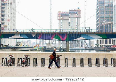 A Businessman Walking On Reuters Plaza In Canary Wharf