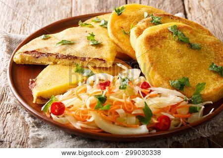 Delicious Vegetarian Fried Pupusas Served With Coleslaw Close-up On A Plate. Horizontal