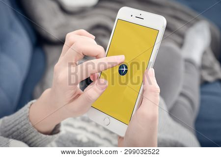 Kyiv, Ukraine - January 24, 2018: Woman Using Expedia App On Apple Iphone 8 Plus At Home For Search 