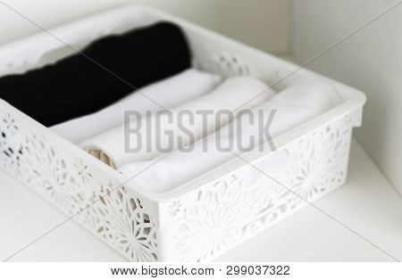 Home Wardrobe With Different Clothes. Small Space Organization. Vertical Storage In A Plastic Box.