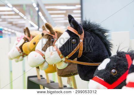 Row Of Multicolored Hobbyhorses - Children Toys.