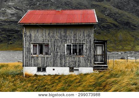 Old Damaged Facade Of A Wooden House In The Village Vinstad At The Coast On Lofoten Islands In Norwa
