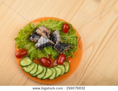 Pieces Of Sardine Iwashi On Lettuce Leaves With Red Tomatoes.