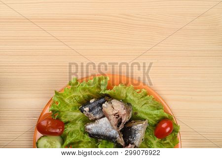 Pieces Of Sardine Iwashi On Lettuce Leaves With Red Tomatoes And Sliced Cucumbers.