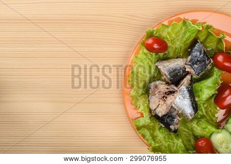 Pieces Of Sardine Iwashi On Lettuce Leaves With Red Tomatoes And Sliced Cucumbers.