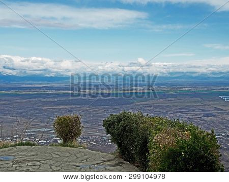 Top View Of Alazani Valley In Georgia In Springtime, In The Distance Through The Haze Visible To The