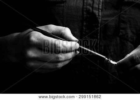 Female Hand Elegantly Holding An Ink Pen With A Metal Tip Close-up On A Black Background. Classic Fo