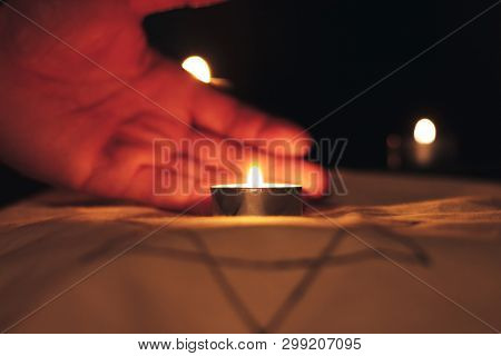 Candles Burning Over The Star Of David In Memory Of The Dead.