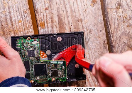 A Man Breaks A Computer Using Locksmith Tools.