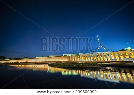 Facade Of New Parliament House In Canberra On Capitol Hill At Sunset With Bright Illumination Reflec
