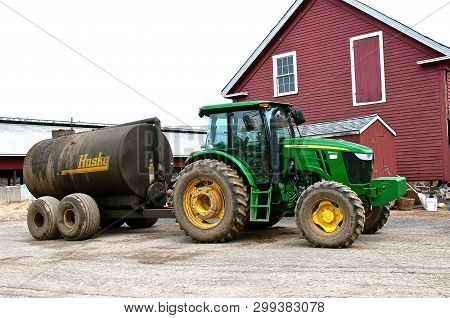 Rowley, Massachusetts, April 28, 2019: The 6140 John Deere Tractor  Pulling A Husky Manure Spreader 