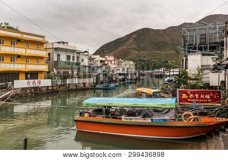 Hong Kong, China - March 7, 2019: Tai O Fishing Village. Motor Sloop For Visitors On River Flanked O