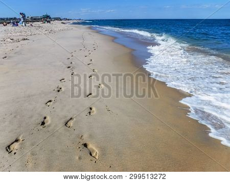 Footprints In The Sand Along The Shoreline In Spring Lake Along The Jersey Shore.
