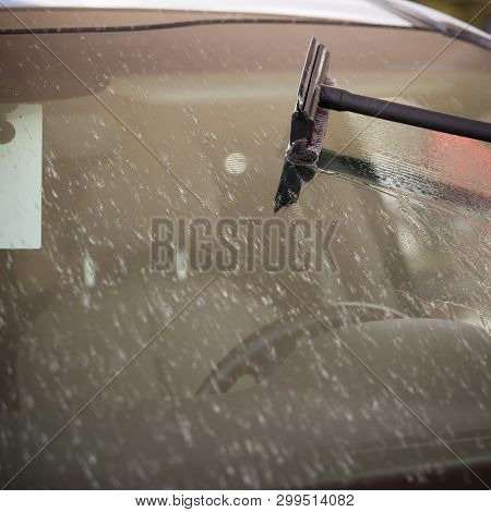 Brush On The Background Of The Windshield Of The Car. The Glass Is Covered With A Large Number Of De
