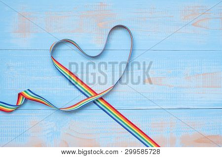 Lgbtq With Heart Shape Rainbow Ribbon On Blue Pastel Wooden Background For Lesbian, Gay, Bisexual, T