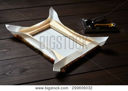 Canvas Wrapping On Wood Stretcher Bar, Staple Gun On Brown Wooden Table