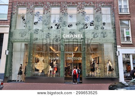 Amsterdam, Netherlands - July 10, 2017: Person Walks By Chanel Fashion Shop At P.c. Hooftstraat In A